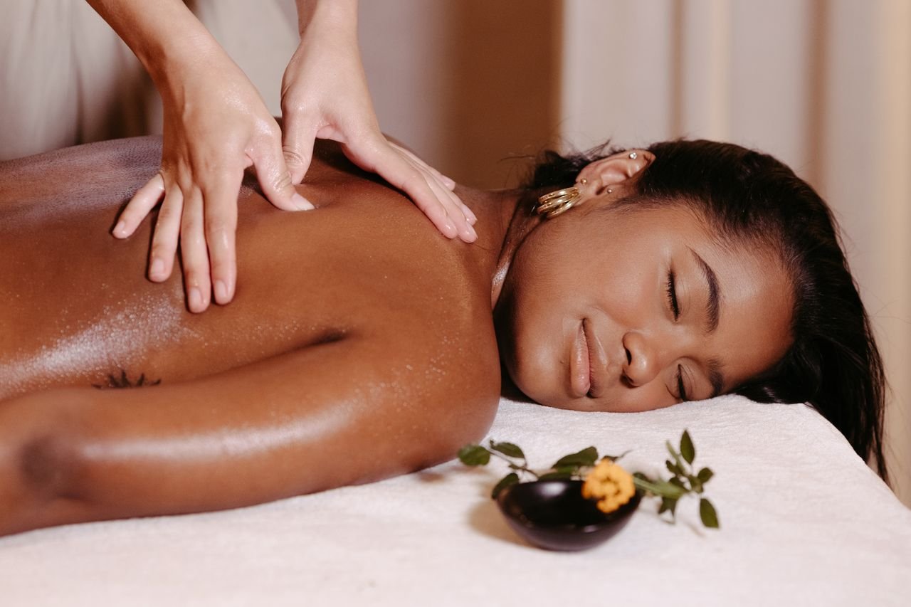 A woman enjoys a therapeutic massage, promoting relaxation and well-being.