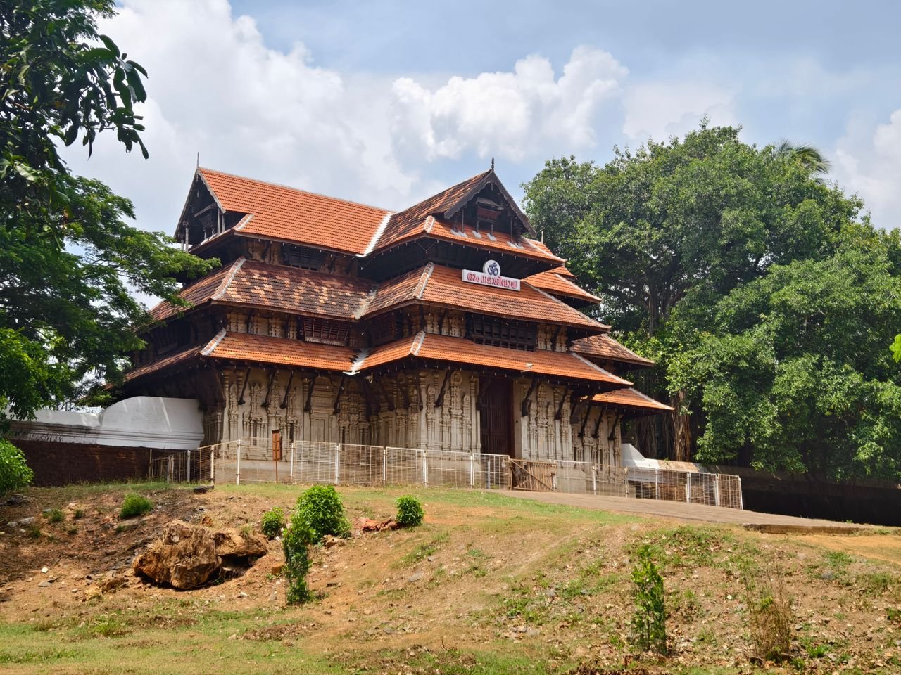 Historic Vadakkunnathan Temple in Thrissur, Kerala with intricate wooden architecture and serene surroundings.
